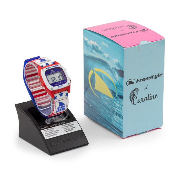 A Caroline Marks Signature Shark Classic Leash Surfin USA watch by Freestyle, displayed beside its vibrant box.