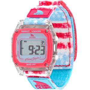 The Freestyle CAROLINE MARKS SIGNATURE SHARK CLASSIC LEASH SURFIN USA watch features a red and blue strap, with the display active.